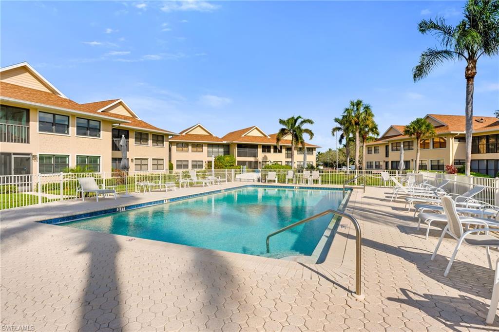 1100 9th Street South, Unit D201 Naples, FL 34102 - Photo 18 of 25 a view of swimming pool with outdoor seating and city view