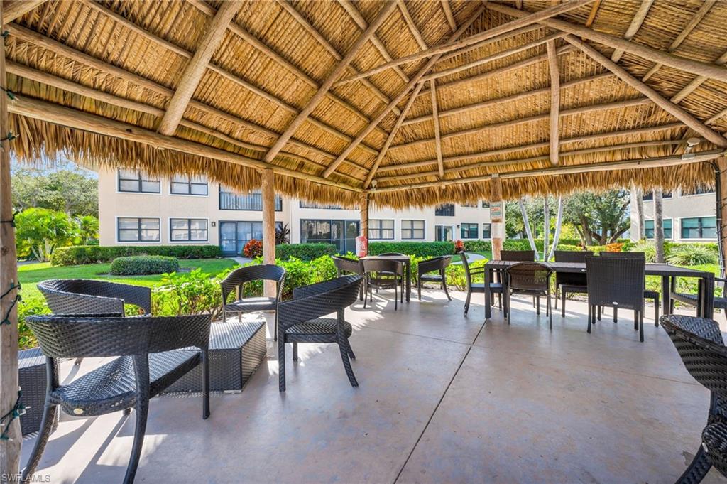 1100 9th Street South, Unit D201 Naples, FL 34102 - Photo 19 of 25 a view of a chairs and table in a patio