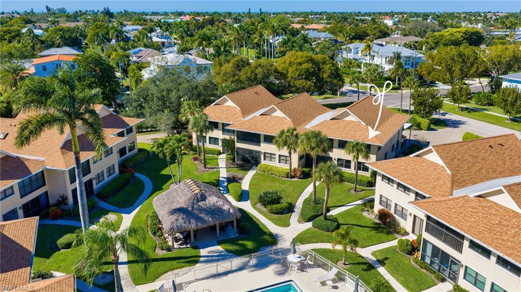1100 9th Street South, Unit D201 Naples, FL 34102 - Photo 20 of 25 an aerial view of house with swimming pool outdoor seating and yard