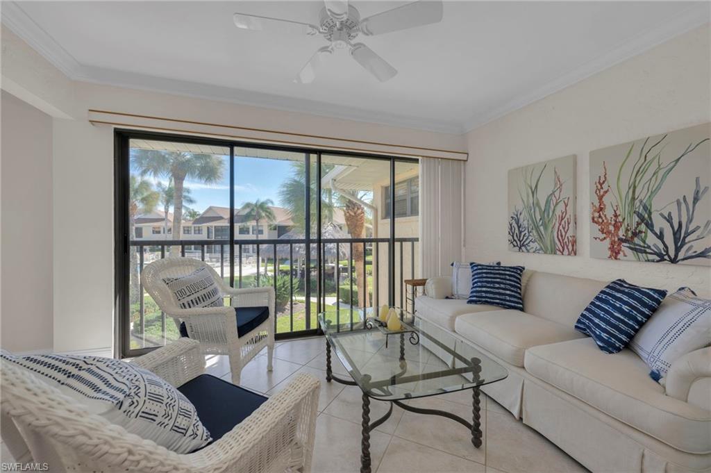 1100 9th Street South, Unit D201 Naples, FL 34102 - Photo 3 of 25 a living room with furniture and a large window