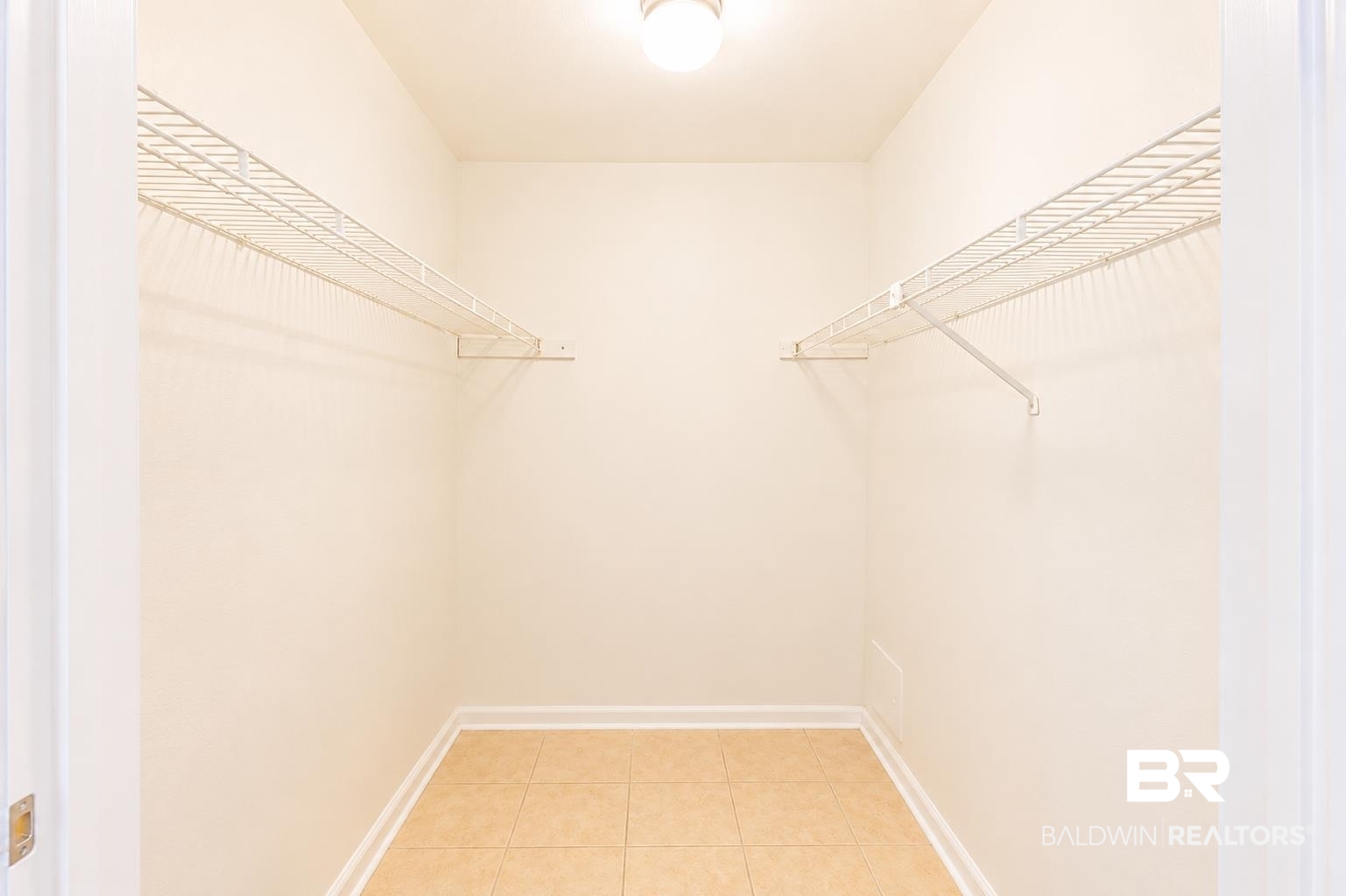 614 East Gate Circle Foley, AL 36535 - Photo 25 of 31 Walk-in closet featuring wire shelving, ceiling-mounted light fixture, and tile flooring