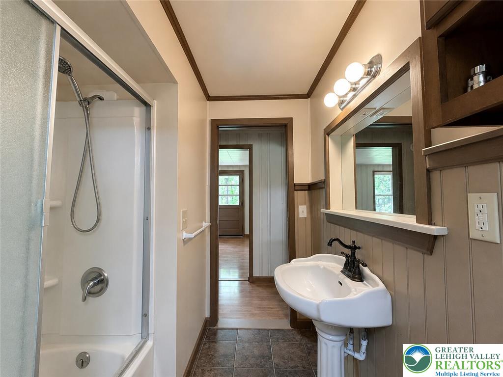 4995 Mountain Road Slatington, PA 18080 - Photo 16 of 30 A well-appointed bathroom features a pedestal sink and convenient tub-shower combination.