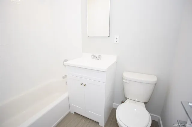 a white toilet sitting next to a bathroom sink