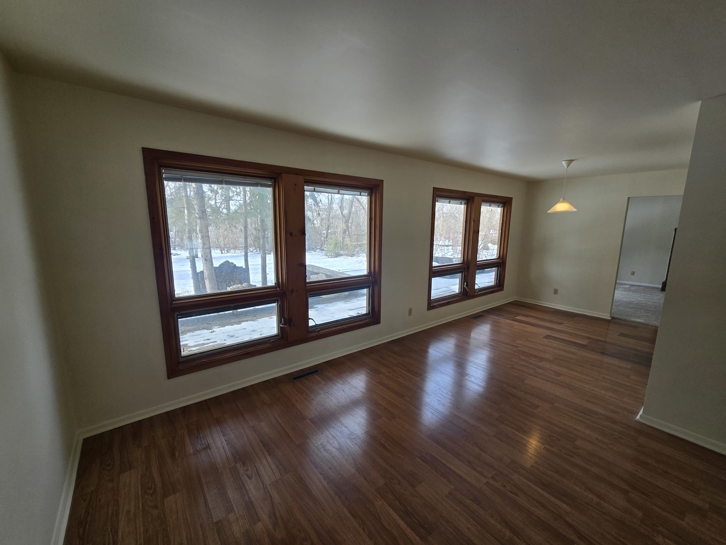 905 Hickory Road Woodstock, IL 60098 - Photo 11 of 32 a view of an empty room with wooden floor and a window