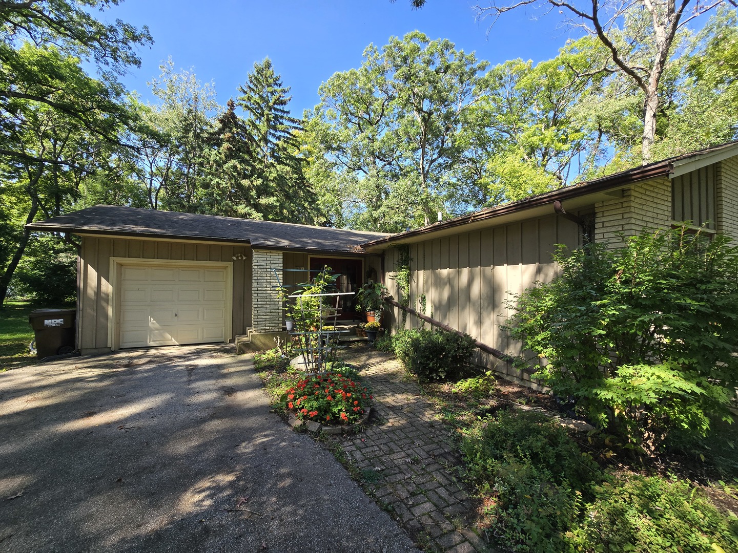 905 Hickory Road Woodstock, IL 60098 - Photo 2 of 32 a backyard of a house with outdoor seating and a lots of trees
