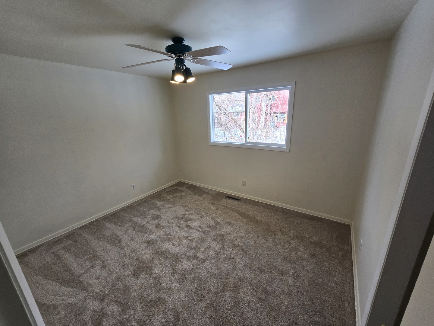 905 Hickory Road Woodstock, IL 60098 - Photo 23 of 32 an empty room with a window and a fan
