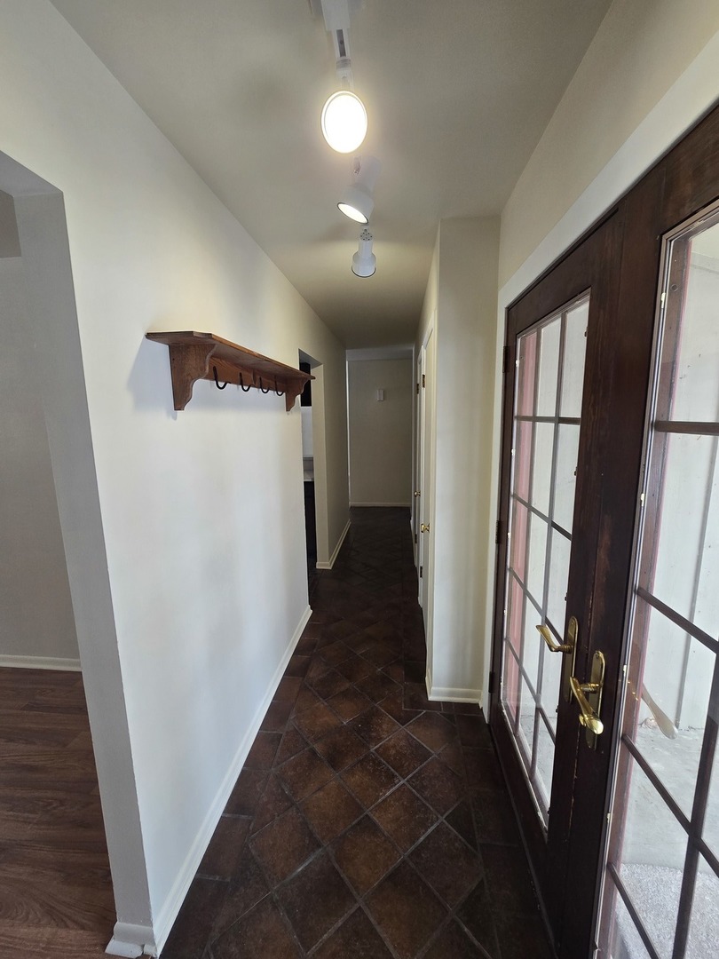 905 Hickory Road Woodstock, IL 60098 - Photo 8 of 32 a view of entryway with stairs and a window
