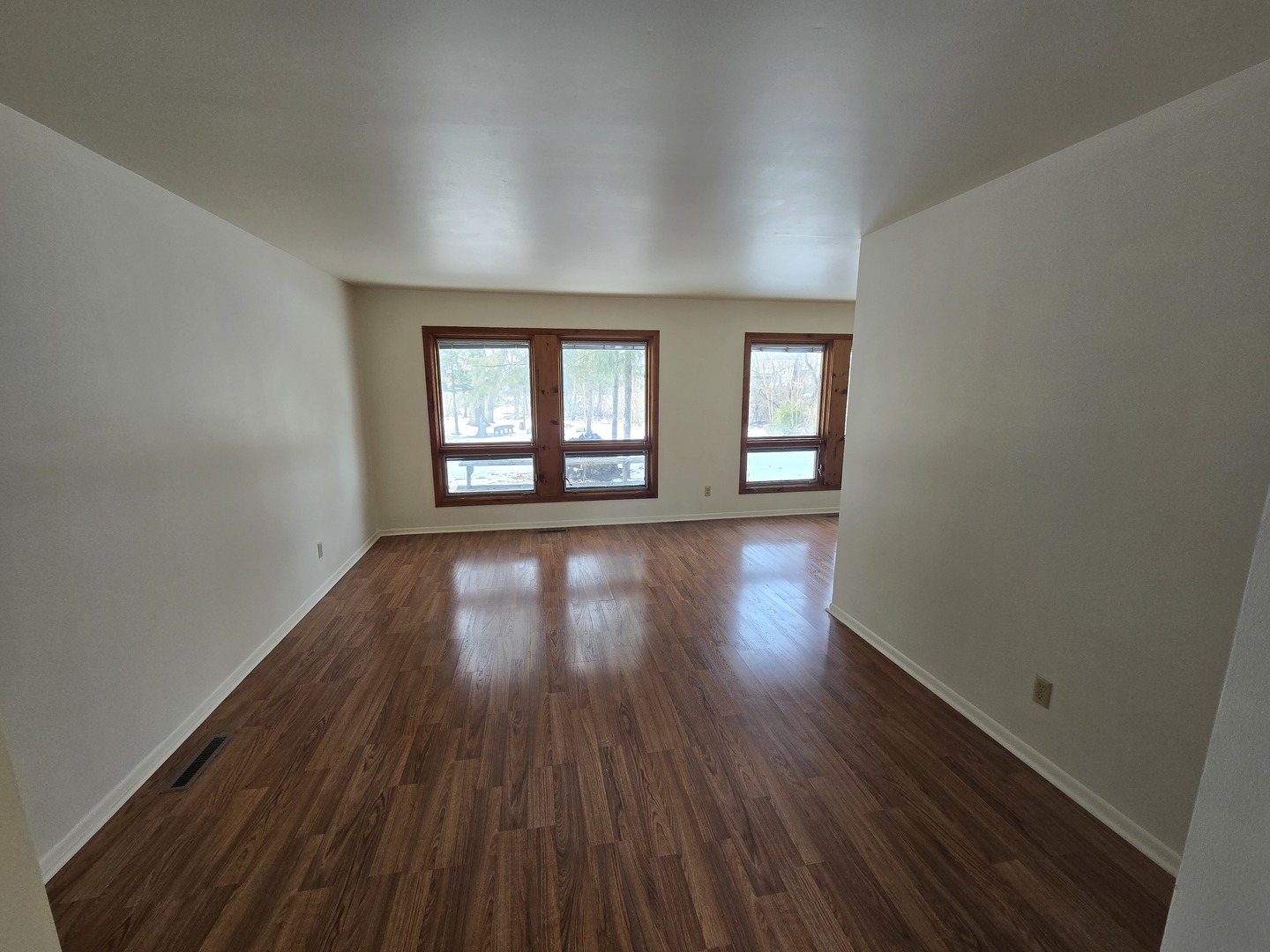 905 Hickory Road Woodstock, IL 60098 - Photo 9 of 32 an empty room with wooden floor and windows