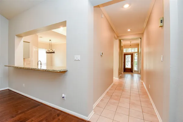 a kitchen with granite countertop a refrigerator and a sink