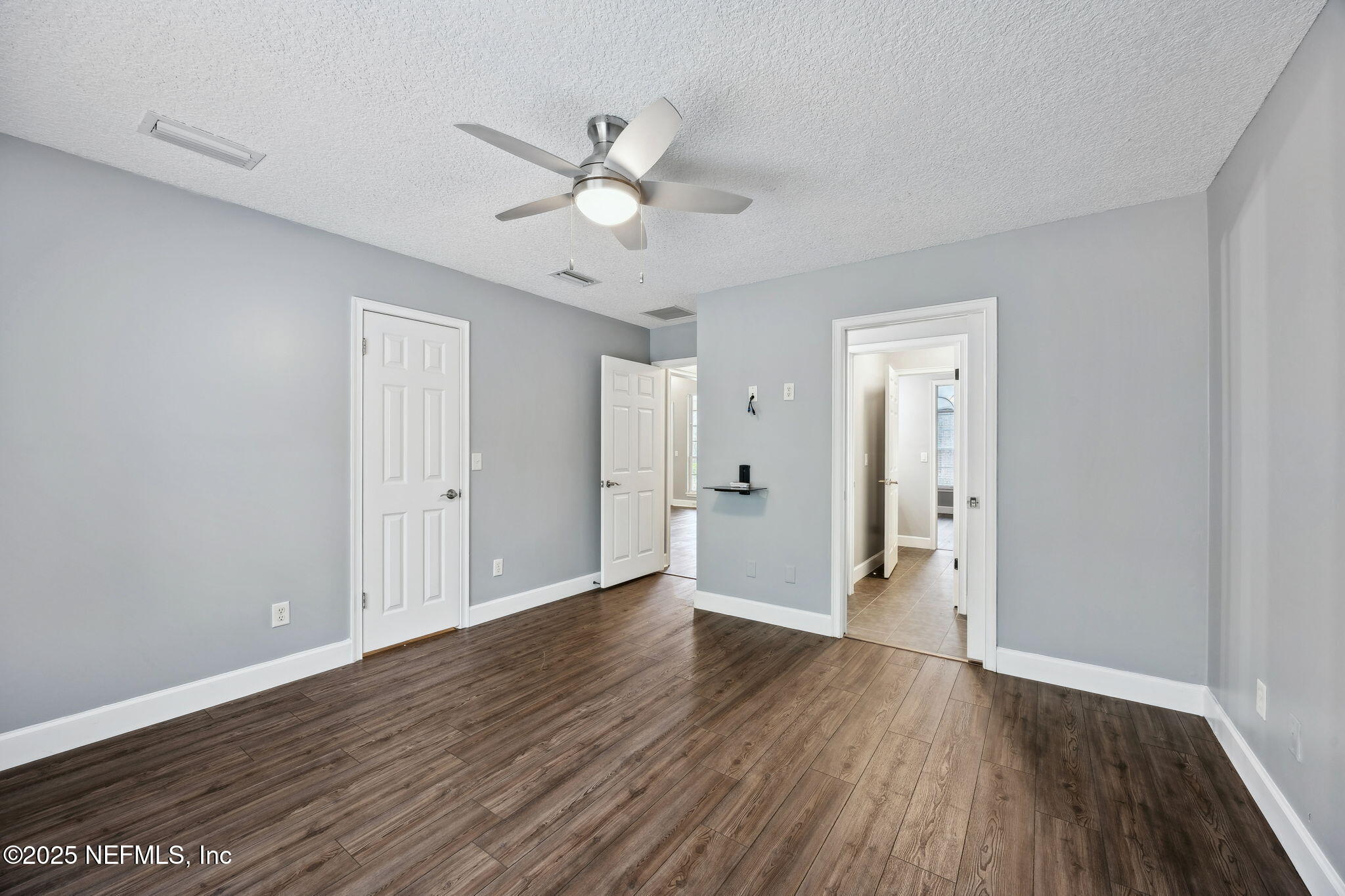 13193 Caldwell Road Jacksonville, FL 32226 - Photo 21 of 50 a view of an empty room with wooden floor