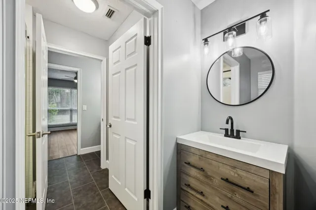 a bathroom with a sink and a mirror