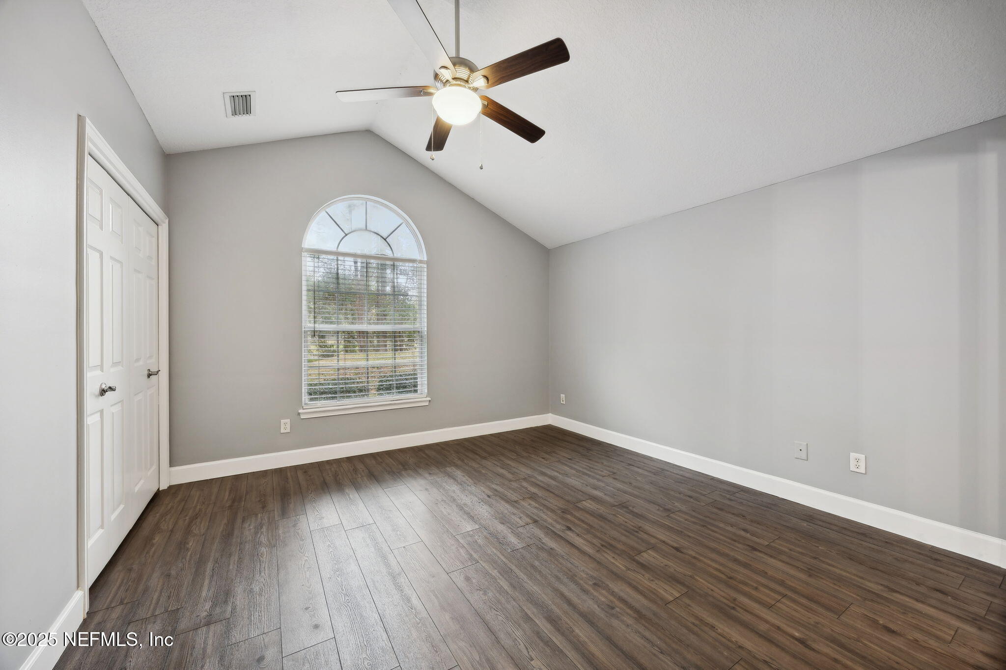 13193 Caldwell Road Jacksonville, FL 32226 - Photo 27 of 50 an empty room with wooden floor chandelier fan and windows
