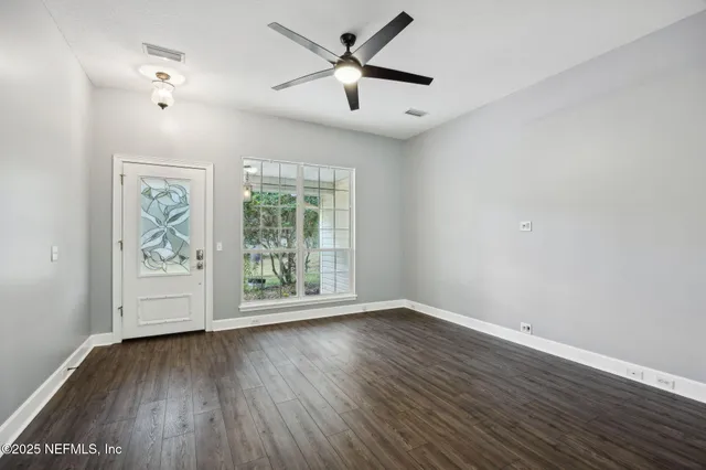 wooden floor in an empty room with a window