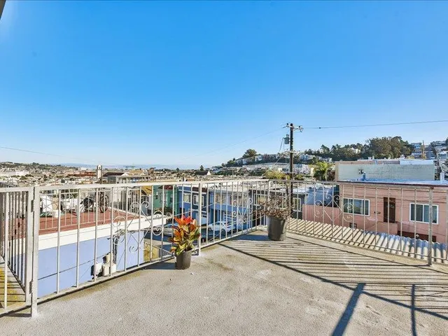 a view of a building with car parked