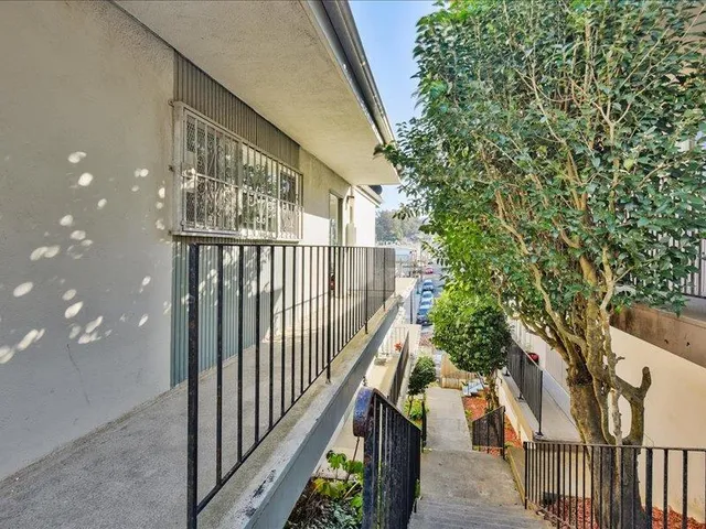 a kitchen with granite countertop a refrigerator stove and sink