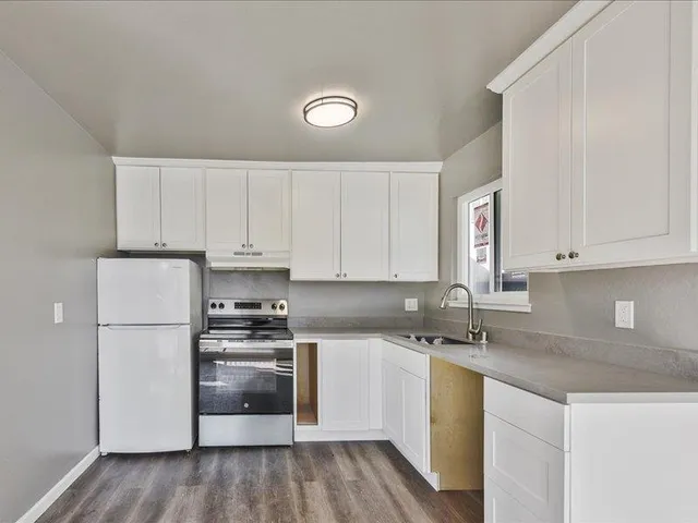 a kitchen with a sink a stove and refrigerator