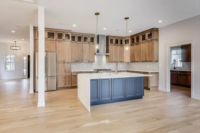 a kitchen with kitchen island granite countertop wooden cabinets and white appliances