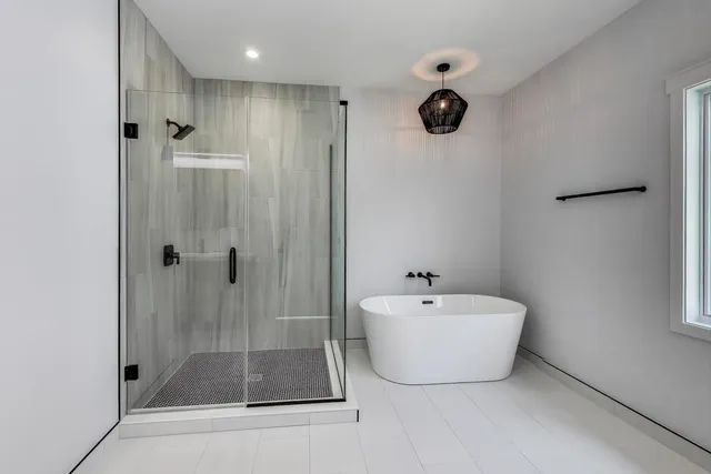 a bathroom with a bathtub and shower