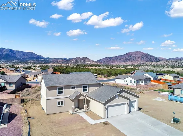 a view of a house with a yard covered in snow