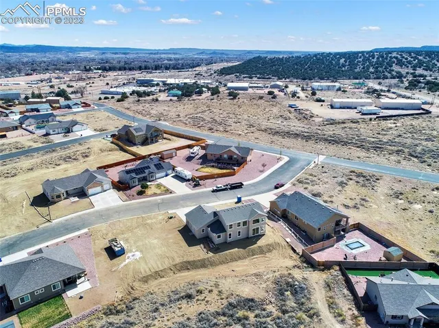 a view of a dining room with furniture a chandelier and wooden floor