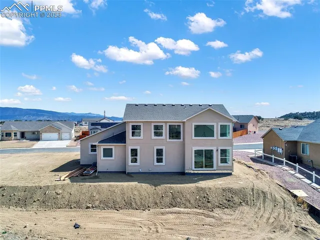 a kitchen with white cabinets a sink and a window