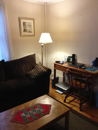 a living room with furniture and a lamp