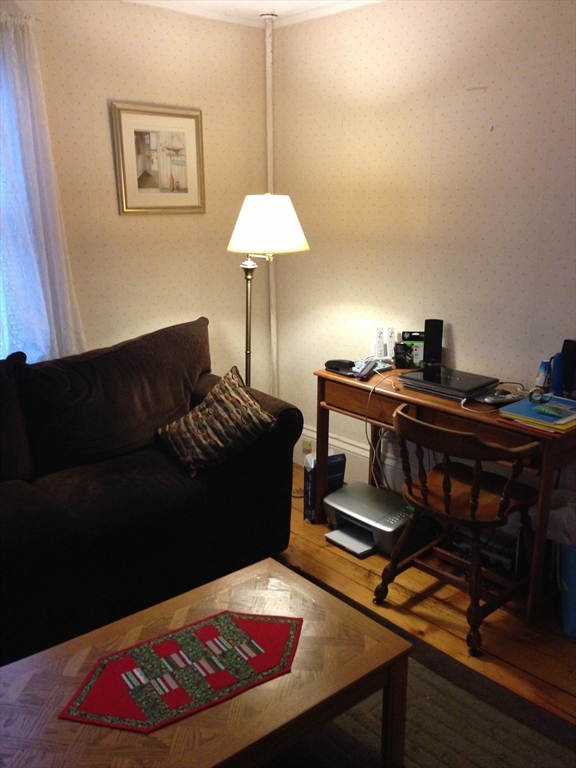 5 Lincoln Street, Unit 4 Plymouth, MA 02360 - Photo 4 of 9 a living room with furniture and a lamp