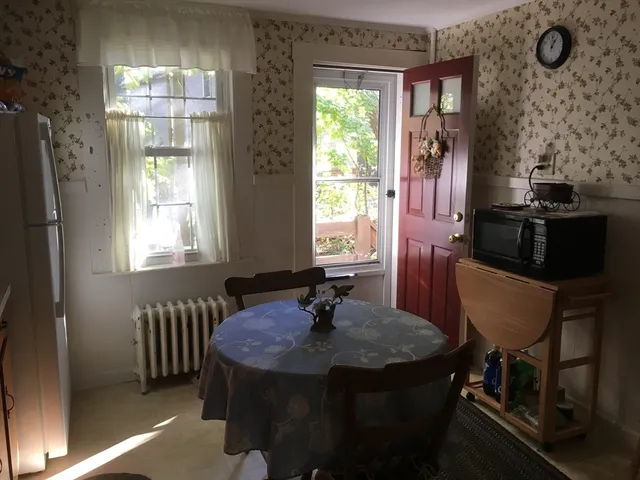 a dining room with furniture and window