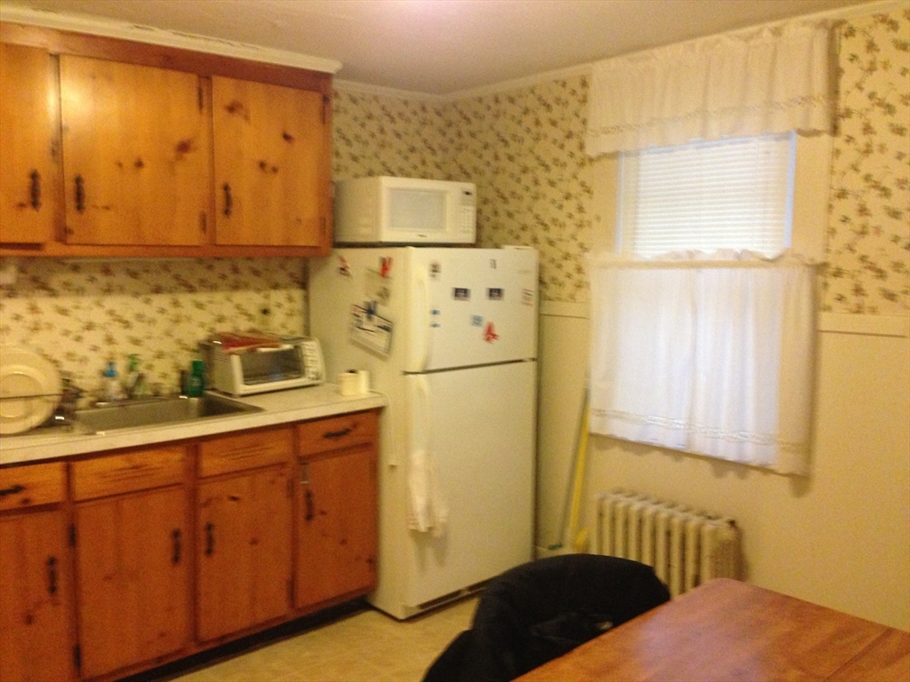 5 Lincoln Street, Unit 4 Plymouth, MA 02360 - Photo 6 of 9 a bedroom with a bed and cabinets