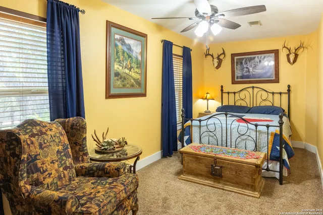 a bed sitting in a bedroom next to a large window