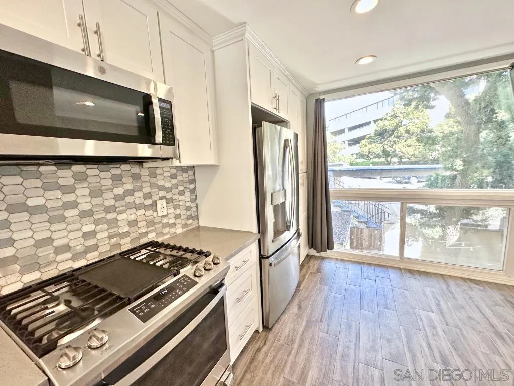 6855 Friars Road, Unit 14 San Diego, CA 92108 - Photo 11 of 31 a stove top oven sitting inside of a kitchen