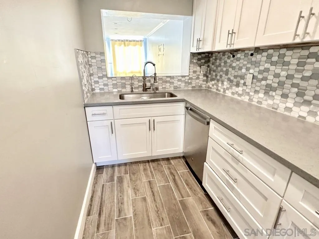 6855 Friars Road, Unit 14 San Diego, CA 92108 - Photo 13 of 31 a kitchen with a sink a stove a microwave and cabinets