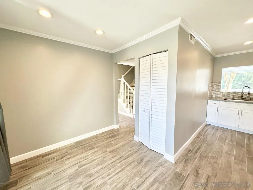 6855 Friars Road, Unit 14 San Diego, CA 92108 - Photo 19 of 31 a view of a kitchen with wooden floor and a sink