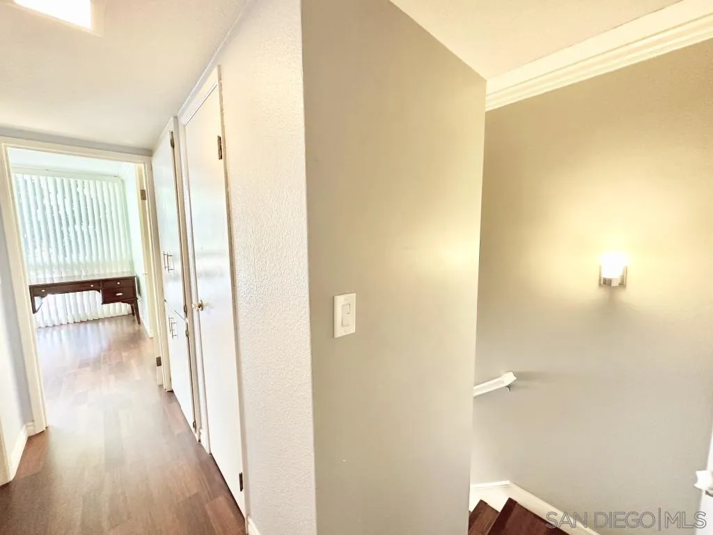 6855 Friars Road, Unit 14 San Diego, CA 92108 - Photo 29 of 31 a view of a hallway with wooden floor