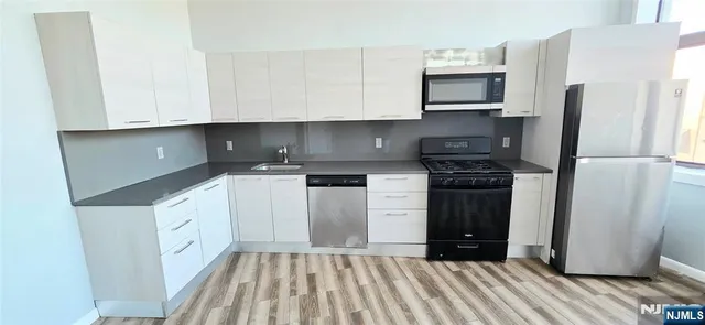 a kitchen with a refrigerator sink and stove