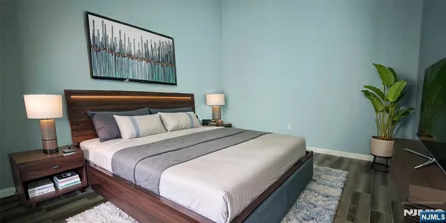 a bed sitting in a bedroom next to a window