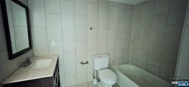 a white toilet sitting next to a bathroom sink