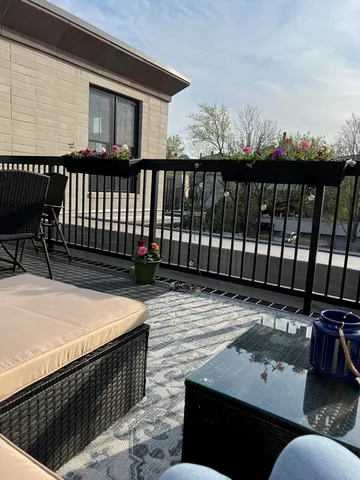 a balcony with table and chairs