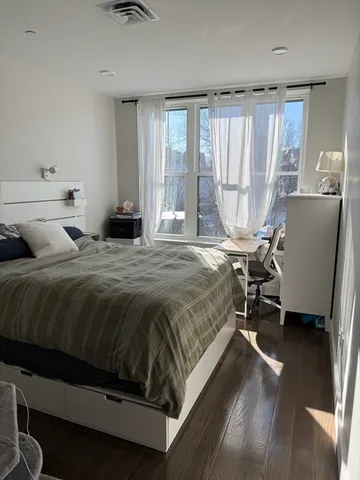 a bedroom with a bed a table and chair