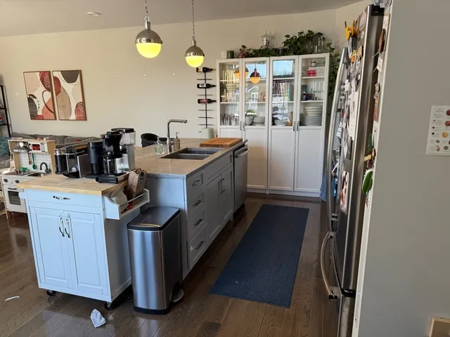 a kitchen with refrigerator and cabinets