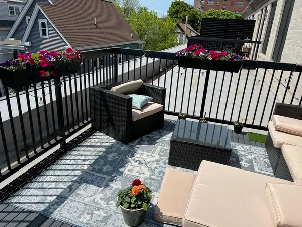 a view of a chairs and tables in the back yard of the house