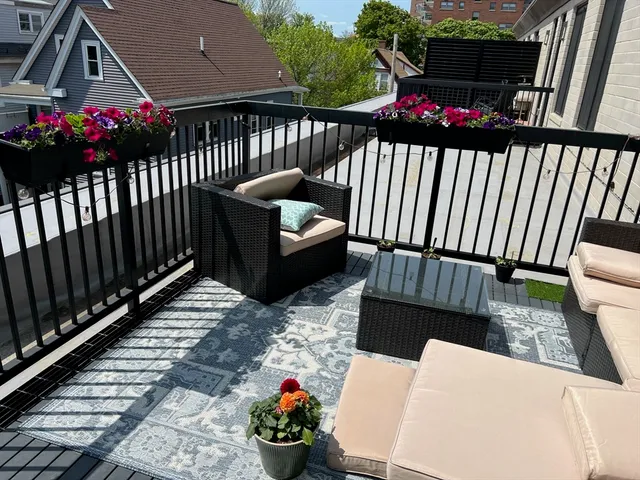 a view of a chairs and tables in the back yard of the house