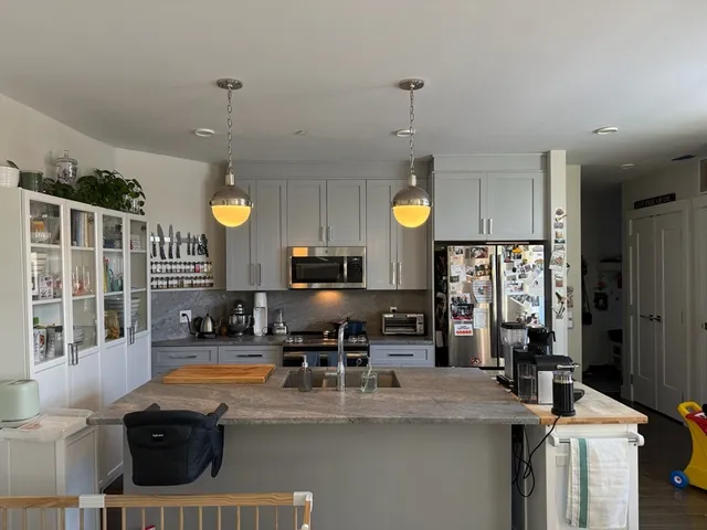 a kitchen with refrigerator a stove and a sink