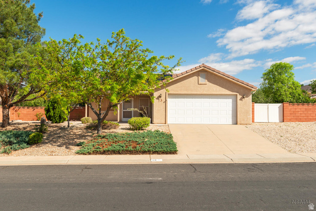 53 Cyndi Lane La Verkin, UT 84745 - Photo 1 of 1 View of front of property featuring an attached garage, concrete driveway, and stucco siding