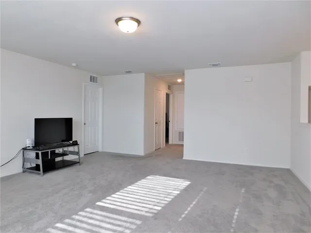 a view of room with furniture and tv