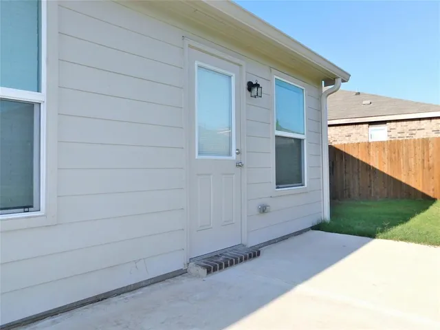 a view of front door and yard