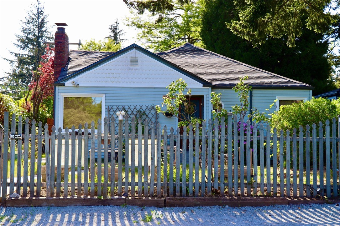 a view of a house with wooden fence