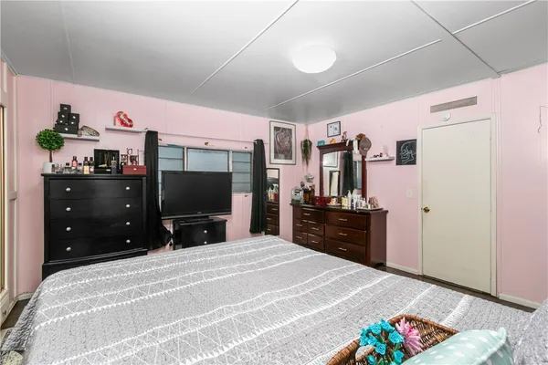 a bedroom with a bed and a flat screen tv