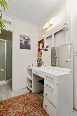 a room with a baby crib and a sink