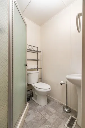 a white toilet sitting next to a bathroom sink